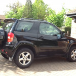 Black Jeep parked in a driveway