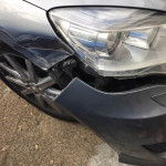 Grey car with a cracked front bumper